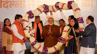 Prime Minister Narendra Modi being garlanded by BJP MPs Manoj Tiwari, Ramvir Singh Bidhuri and Bansuri Swaraj during celebrations at the BJP HQ after the party won the Delhi Assembly election, in New Delhi, Saturday. (PTI) Prime Minister Narendra Modi being garlanded by BJP MPs Manoj Tiwari, Ramvir Singh Bidhuri and Bansuri Swaraj during celebrations at the BJP HQ after the party won the Delhi Assembly election, in New Delhi, Saturday. (PTI)