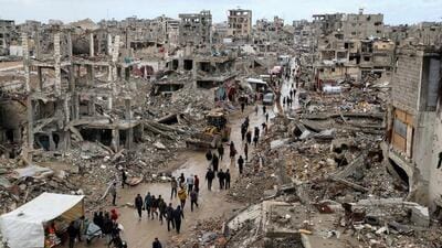 Palestinians walk past the rubble of buildings destroyed during the Israeli offensive, on a rainy day, amid a ceasefire between Israel and Hamas, in Gaza City, on Feb 6. (REUTERS) Palestinians walk past the rubble of buildings destroyed during the Israeli offensive, on a rainy day, amid a ceasefire between Israel and Hamas, in Gaza City, on Feb 6. (REUTERS)