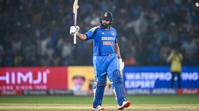 India's captain Rohit Sharma celebrates after scoring a century (100 runs) during the second one-day international (ODI) cricket match between India and England at the Barabati Stadium in Cuttack. (AFP) India's captain Rohit Sharma celebrates after scoring a century (100 runs) during the second one-day international (ODI) cricket match between India and England at the Barabati Stadium in Cuttack. (AFP)