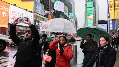 People walk with umbrellas during a winter storm in Time Square in New York City, U.S., February 6, 2025. REUTERS/Jeenah Moon (REUTERS)