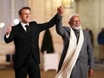 Indian Prime Minister Narendra Modi, right, is greeted by President of France Emmanuel Macron as he arrives for a reception at Palais de l'Elysee in Paris on Monday, Feb. 10, 2025. (Sean Kilpatrick/The Canadian Press via AP)