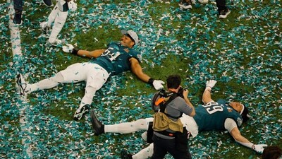 Philadelphia Eagles' Jeremiah Trotter Jr. and Johnny Wilson make confetti angels as they celebrate after winning Super Bowl LIX. (REUTERS)