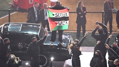 A protestor holds a Palestinian flag with the words "Gaza" and "Sudan" as US rapper Kendrick Lamar performs during Super Bowl LIX Chiefs vs Eagles Apple Music Halftime Show at Caesars Superdome in New Orleans, Louisiana, February 9, 2025. (Photo by Chandan Khanna / AFP) (AFP) A protestor holds a Palestinian flag with the words "Gaza" and "Sudan" as US rapper Kendrick Lamar performs during Super Bowl LIX Chiefs vs Eagles Apple Music Halftime Show at Caesars Superdome in New Orleans, Louisiana, February 9, 2025. (Photo by Chandan Khanna / AFP) (AFP)
