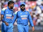 India's captain Rohit Sharma (R) speaks with his teammate Hardik Pandya