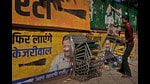 A worker removes and stacks chairs from Aam Aadmi Party (AAP) office as the party trails in Delhi state election in New Delhi,India, Saturday, Feb. 8, 2025. Photographs of party leader Arvind Kejriwal, are seen on the wall. (AP Photo/Manish Swarup) (AP)