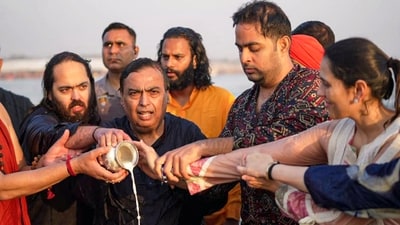 Reliance Industries Chairman Mukesh Ambani, with his family, performs a ritual while taking a holy dip during the Mahakumbh Mela. They were accompanied by Ambani's mother-in-law, Poonamben Dalal, and sister-in-law, Mamthaben Dalal. (PTI) Reliance Industries Chairman Mukesh Ambani, with his family, performs a ritual while taking a holy dip during the Mahakumbh Mela. They were accompanied by Ambani's mother-in-law, Poonamben Dalal, and sister-in-law, Mamthaben Dalal. (PTI)