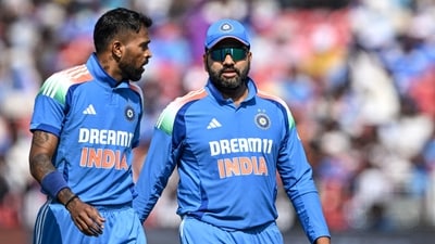 India's captain Rohit Sharma (R) speaks with his teammate Hardik Pandya (AFP)