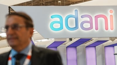 Bengaluru: An official walks past the stall of Adani Defence and Aerospace during the inauguration of Aero India 2023, at Yelahanka air base in Bengaluru, Monday, (PTI) Bengaluru: An official walks past the stall of Adani Defence and Aerospace during the inauguration of Aero India 2023, at Yelahanka air base in Bengaluru, Monday, (PTI)