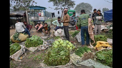 Vegetable vendors wait for customers at a local market in New Delhi on February 1, 2025. India's finance minister unveiled broad income tax cuts on February 1, as Prime Minister Narendra Modi's government looks to bolster consumption and perk up a slowing economy. Consumers have been burdened by high food inflation and weak wage growth, two factors impacting urban consumption. (Photo by Arun SANKAR / AFP) (AFP)