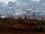 Soldiers stand on top of a tank on the Israeli side at the border with Gaza, amid a ceasefire between Israel and Hamas, as seen from Israel, on February 12, 2025. 