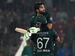 Pakistan's Mohammad Rizwan, back, is congratulated by teammate Salman Ali Agha celebrates after scoring century during the tri-series ODI Pakistan's Mohammad Rizwan, back, is congratulated by teammate Salman Ali Agha celebrates after scoring century during the tri-series ODI