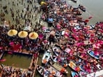 Government officials shower flower petals from a helicopter onto pilgrims gathered at the Sangam, the confluence of three rivers, the Ganges, the Yamuna and the mythical Saraswati, on Maghi Purnima or the full-moon day during the Maha Kumbh festival in Prayagraj.
