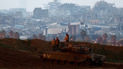 Soldiers stand on top of a tank on the Israeli side at the border with Gaza, amid a ceasefire between Israel and Hamas, as seen from Israel, on February 12, 2025. (Reuters)