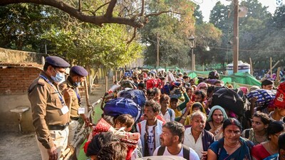 Security personnel keep vigil as passengers move towards the Prayagraj railway station amid a massive rush on 'Maghi Purnima', during the Maha Kumbh Mela 2025, Wednesday, Feb. 12, 2025. (PTI) Security personnel keep vigil as passengers move towards the Prayagraj railway station amid a massive rush on 'Maghi Purnima', during the Maha Kumbh Mela 2025, Wednesday, Feb. 12, 2025. (PTI)
