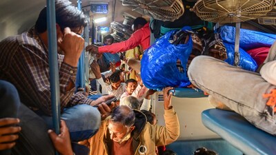 Passengers in a crowded coach of a train at the Jhusi railway station amid a massive rush on ‘Maghi Purnima’. (PTI) Passengers in a crowded coach of a train at the Jhusi railway station amid a massive rush on ‘Maghi Purnima’. (PTI)