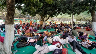 Passengers wait at Khusro Bagh after their trains were delayed amid a massive rush on 'Maghi Purnima', during the Maha Kumbh Mela 2025, in Prayagraj. (PTI) Passengers wait at Khusro Bagh after their trains were delayed amid a massive rush on 'Maghi Purnima', during the Maha Kumbh Mela 2025, in Prayagraj. (PTI)