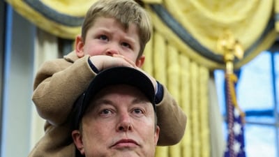 Elon Musk carries his son X AE A-XII on his shoulders in the Oval Office (REUTERS)