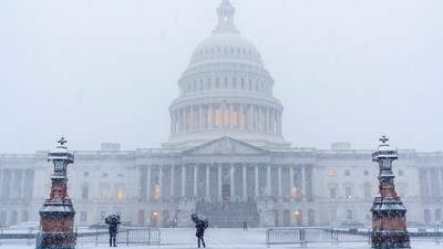 People sheltering with black umbrella's walk through snow at the Capitol, during a snowstorm in Washington. (AP Photo/Jacquelyn Martin) People sheltering with black umbrella's walk through snow at the Capitol, during a snowstorm in Washington. (AP Photo/Jacquelyn Martin)