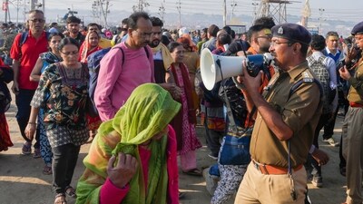 A policeman makes announcements to manage devotees arriving to take a holy dip at Sangam on the occasion of 'Maghi Purnima', during the Maha Kumbh Mela 2025, in Prayagraj, (PTI) A policeman makes announcements to manage devotees arriving to take a holy dip at Sangam on the occasion of 'Maghi Purnima', during the Maha Kumbh Mela 2025, in Prayagraj, (PTI)