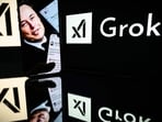 This photograph taken on January 13, 2025 in Toulouse shows screens displaying the logo of Grok, a generative artificial intelligence chatbot developed by xAI, the American company specializing in artificial intelligence and it's founder South African businessman Elon Musk.