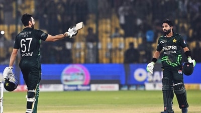 Pakistan's Salman Agha (L) celebrates after a century score (100 runs) as Mohammad Rizwan (R) looks on during the Tri-Nation series third one-day international (ODI) cricket match between Pakistan and South Africa at the National Stadium in Karachi on February 12, 2025. (Photo by Asif HASSAN / AFP) (AFP)