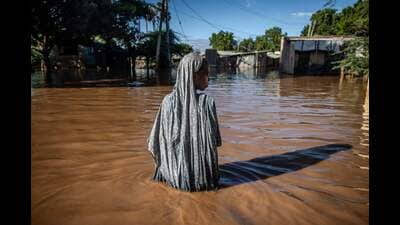 TOPSHOT - -- AFP PICTURES OF THE YEAR 2024 -- A woman wades through flood waters at an inundated residential area in Garissa, on May 9, 2024.. (Photo by LUIS TATO / AFP) / AFP PICTURES OF THE YEAR 2024 (AFP) TOPSHOT - -- AFP PICTURES OF THE YEAR 2024 -- A woman wades through flood waters at an inundated residential area in Garissa, on May 9, 2024.. (Photo by LUIS TATO / AFP) / AFP PICTURES OF THE YEAR 2024 (AFP)