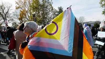 People hold LGBTQ+ flags outside the US Supreme Court on December 4, 2024 in Washington, DC, during oral argument on whether states can ban certain gender transition medical treatments for young people. The case was brought by three transgender teens, their parents and a doctor who are seeking to ensure health-care access they say is critical. (Photo by ROBERTO SCHMIDT / AFP) (AFP) People hold LGBTQ+ flags outside the US Supreme Court on December 4, 2024 in Washington, DC, during oral argument on whether states can ban certain gender transition medical treatments for young people. The case was brought by three transgender teens, their parents and a doctor who are seeking to ensure health-care access they say is critical. (Photo by ROBERTO SCHMIDT / AFP) (AFP)