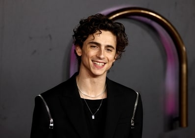 Timothee Chalamet smiles for the camera at the Dune screening in London. (REUTERS)