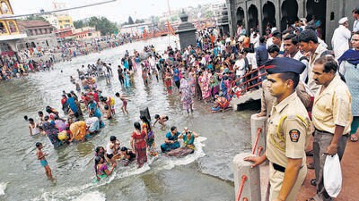 Nashik, India - July 13, 2015 : A police constable keeps a close watch as devotees take bath at Ram Kund on the eve of the flag hoisting of Kumbh Mela at in Nashik, India, on Monday, July 13, 2015. (Photo by Arijit Sen/ Hindustan Times) (Hindustan Times) Nashik, India - July 13, 2015 : A police constable keeps a close watch as devotees take bath at Ram Kund on the eve of the flag hoisting of Kumbh Mela at in Nashik, India, on Monday, July 13, 2015. (Photo by Arijit Sen/ Hindustan Times) (Hindustan Times)
