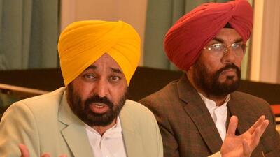 Punjab chief minister Bhagwant Mann with state NRI affairs minister Kuldeep Singh Dhaliwal addressing a press conference in Amritsar on Friday. (Sameer Sehgal/HT)