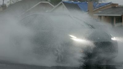 Large parts of Southern California are being affected by the storm, and some emergency evacuations have been ordered due to concerns about rock slides and debris flows in areas that recently suffered fire damage, such as hillside areas affected by the Palisades and Eaton fires. In this picture, a Tesla driver navigates the rain near the Eaton Fire burn zone as a strong atmospheric river storm affects the area. (Getty Images via AFP) Large parts of Southern California are being affected by the storm, and some emergency evacuations have been ordered due to concerns about rock slides and debris flows in areas that recently suffered fire damage, such as hillside areas affected by the Palisades and Eaton fires. In this picture, a Tesla driver navigates the rain near the Eaton Fire burn zone as a strong atmospheric river storm affects the area. (Getty Images via AFP)