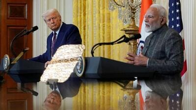 US President Donald Trump and Prime Minister Narendra Modi are pictured in a mirror as they attend a joint press conference at the White House. (REUTERS)