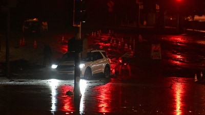 During a storm in Malibu, California, a driver tries to escape the mud-covered intersection at Sunset Blvd and Pacific Coast Highway, close to the Palisades Fire zone. (AFP) During a storm in Malibu, California, a driver tries to escape the mud-covered intersection at Sunset Blvd and Pacific Coast Highway, close to the Palisades Fire zone. (AFP)