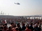 A helicopter drops flower petals on the devotees taking a dip at Sangam in the ongoing Maha Kumbh in Prayagraj.