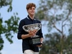 Jannik Sinner in a photoshoot with the Australian Open men's singles trophy.