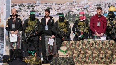 Israeli hostages Iair Horn, 46, left, Sagui Dekel Chen, 36, center left, and Alexander Troufanov, 29, right, are escorted by Hamas and islamic Jihad fighters as they are handed over to the Red Cross in Khan Younis, Gaza Strip, Saturday, Feb. 15, 2025. Israeli hostages Iair Horn, 46, left, Sagui Dekel Chen, 36, center left, and Alexander Troufanov, 29, right, are escorted by Hamas and islamic Jihad fighters as they are handed over to the Red Cross in Khan Younis, Gaza Strip, Saturday, Feb. 15, 2025.