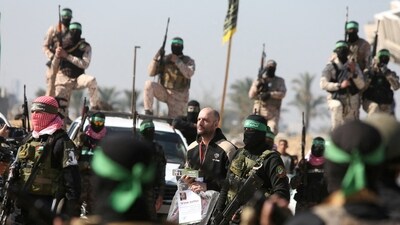 Lair Horn, a hostage held in Gaza since the deadly October 7, 2023 attack, is escorted by Palestinian Hamas militants and Islamic Jihad militants as part of a ceasefire and a hostages-prisoners swap deal between Hamas and Israel. (Reuters)