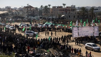 Red Cross vehicles enter an area secured by Palestinian Hamas fighters, before receiving Israeli hostages in Khan Yunis in the southern Gaza Strip on February 15, 2025. (AFP) Red Cross vehicles enter an area secured by Palestinian Hamas fighters, before receiving Israeli hostages in Khan Yunis in the southern Gaza Strip on February 15, 2025. (AFP)