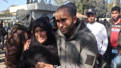 Another freed Palestinian prisoner poses with a relative as they reunite in a warm embrace after a long period of hardships. &nbsp;(Photo by Eyad BABA / AFP) (AFP)