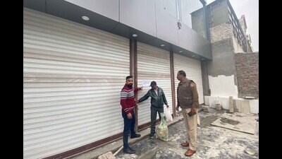 MC officials seal two commercial buildings in BRS Nagar in Ludhiana on Sunday. (HT photo)
