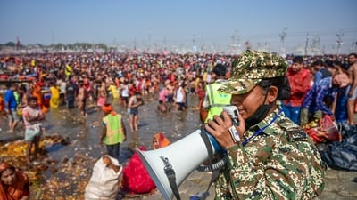 A security personnel makes announcements to manage the rush of devotees during the ongoing Mahakumbh Mela 2025, in Prayagraj, Uttar Pradesh, Saturday. (PTI) A security personnel makes announcements to manage the rush of devotees during the ongoing Mahakumbh Mela 2025, in Prayagraj, Uttar Pradesh, Saturday. (PTI)