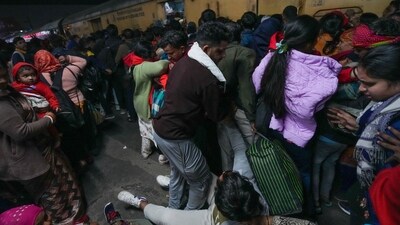 A man falls amid a huge rush of passengers for boarding an overcrowded train for Prayagraj's Mahakumbh, at the New Delhi railway station, on Saturday, February 15, 2025. At least 18 people were killed and more than a dozen injured in a stampede that broke out late Saturday night at the crowded railway station. (PTI) A man falls amid a huge rush of passengers for boarding an overcrowded train for Prayagraj's Mahakumbh, at the New Delhi railway station, on Saturday, February 15, 2025. At least 18 people were killed and more than a dozen injured in a stampede that broke out late Saturday night at the crowded railway station. (PTI)