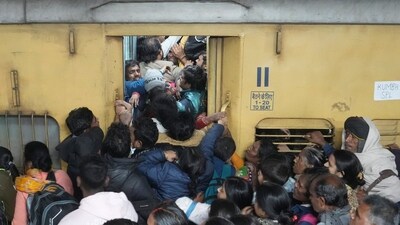 People board an overcrowded train for Prayagraj's Mahakumbh, at the New Delhi railway station. (PTI) People board an overcrowded train for Prayagraj's Mahakumbh, at the New Delhi railway station. (PTI)