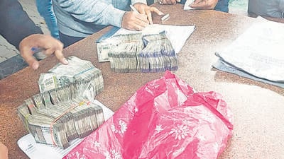 Relative of a victim being handed over ex-gratia relief in cash and getting other formalities done after the stampede. (HT Photo) Relative of a victim being handed over ex-gratia relief in cash and getting other formalities done after the stampede. (HT Photo)