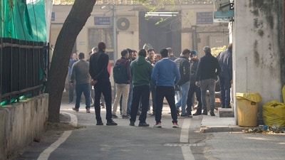 People wait outside the mortuary at LNJP Hospital in New Delhi on Sunday as families gather to identify their loved ones lost in the tragic incident. (PTI) People wait outside the mortuary at LNJP Hospital in New Delhi on Sunday as families gather to identify their loved ones lost in the tragic incident. (PTI)