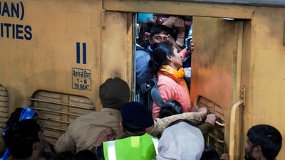 Passengers board an overcrowded train for Prayagraj’s Maha Kumbh at New Delhi Railway Station on Saturday. (PTI) Passengers board an overcrowded train for Prayagraj’s Maha Kumbh at New Delhi Railway Station on Saturday. (PTI)