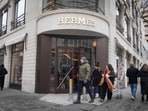 A sign hangs above the entrance of a Hermes retail store in Chicago, Illinois.