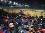 Heavy rush of passengers to catch a train for Prayagraj's Maha Kumbh, at the New Delhi railway station, Saturday, Feb. 15, 2025.