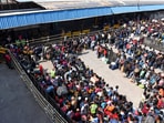  An aerial view of passengers waiting in queues at New Delhi Railway Station, in New Delhi on Monday.