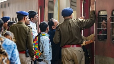 Security personnel manage passengers boarding a train at the New Delhi Railway Station, in New Delhi, Monday, Feb. 17, 2025. At least 18 people were killed and more than a dozen injured in a stampede that broke out Saturday night at the crowded railway station in the national capital. (PTI) Security personnel manage passengers boarding a train at the New Delhi Railway Station, in New Delhi, Monday, Feb. 17, 2025. At least 18 people were killed and more than a dozen injured in a stampede that broke out Saturday night at the crowded railway station in the national capital. (PTI)